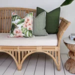 A set of 3 olive outdoor couch cushions including one with a floral design.
