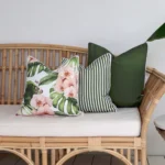 Outdoor seating with 3 olive outdoor cushions on a rattan seat.