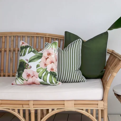 Outdoor seating with 3 olive outdoor cushions on a rattan seat.