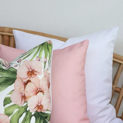 A close-up image of 3 pink outdoor couch cushions provides a thorough view of the colour hue and style.