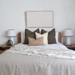The Oscar bed cushions set is neatly arranged on a wooden bed.