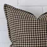 A close up image of this gingham large cushion. The image shows details of its designer fabric more thoroughly.