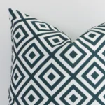 A zoomed view of this outdoor green cushion’s corner that shows a magnified view of its geometric design and its square size.