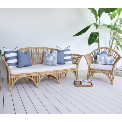 otama-grey-outdoor-lounge-cushions-set---7-covers---COLO1205 7 grey cushions with various designs arranged on rattan seats next to a green plant.