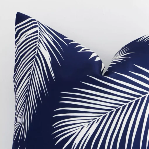 Close up image of top corner of this palm printed navy cushion. This shows the outdoor fabric and square shape up close.