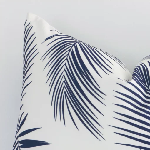 Extreme close up of a rectangle navy cushion. The palm style and outdoor fabric are shown with a much higher degree of detail.