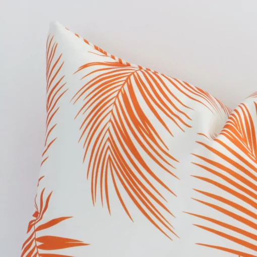 This image shows an orange palm printed cushion cover from a very close range. The rectangle size and outdoor material are more clearly shown.