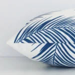 Side image of an outdoor rectangle cushion cover. The teal palm design is visible from the side showing the attachment of the panels.