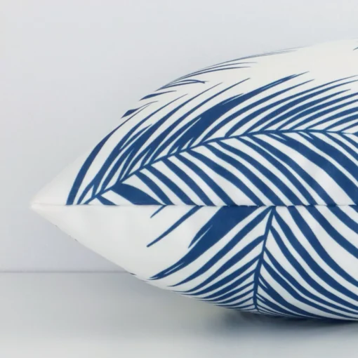 Side image of an outdoor rectangle cushion cover. The teal palm design is visible from the side showing the attachment of the panels.