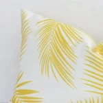 A magnified shot of a yellow palm printed outdoor cushion cover in a rectangle size.