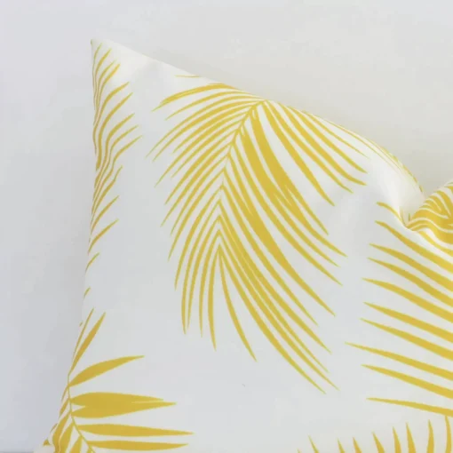 A magnified shot of a yellow palm printed outdoor cushion cover in a rectangle size.