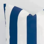 The corner of this outdoor large cushion cover is shown close up. The striped design and navy colour are shown in greater detail.