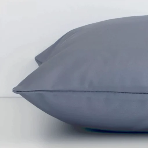 Lateral viewpoint of this outdoor square cushion. The solid grey colour design is shown from the side showing the front and rear panels.