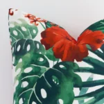 A detailed shot of this red floral cushion cover that has outdoor fabric and a square size.
