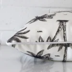 A side shot of an outdoor cushion cover. The angle shows the edge of the square shape and the black and white tone.