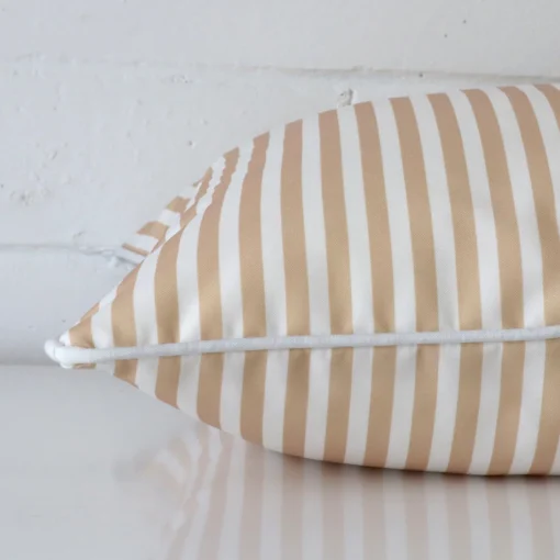 Enlarged image of the side of this outdoor cushion. The angle highlights how the square design and striped decorative finish are joined along the seam.