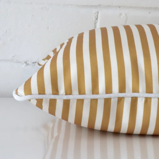 The seams of this outdoor square cushion cover in mustard are shown.