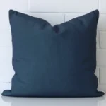 A brick wall that has a cushion cover positioned in front of it. It has an exquisite outdoor material and a lovely large size.