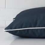 A large outdoor cushion positioned flat to show its seams. The navy blue colour is shown up close.