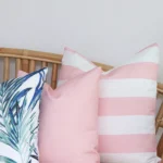 A magnified view of this set of three pink outdoor cushion covers corner shows greater detail.