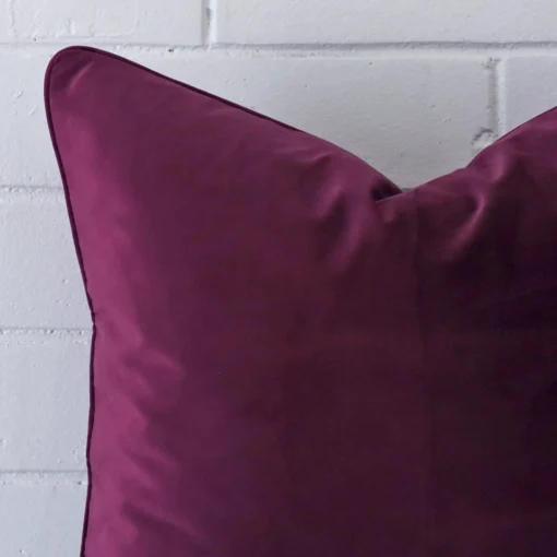 Horizontal edge view of front and back panels of a velvet cushion in a large size and with purple colouring.