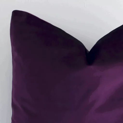 Close up view showing a corner of this solid-coloured velvet cushion in a square size and with velvet colouring.