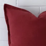 Close up of a linen large cushion in rust.