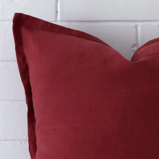 Close up of a linen large cushion in rust.