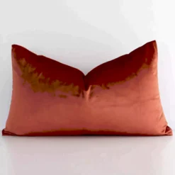 Stylish rust solid-coloured cushion cover constructed from velvet fabric and shown in a rectangle shape.