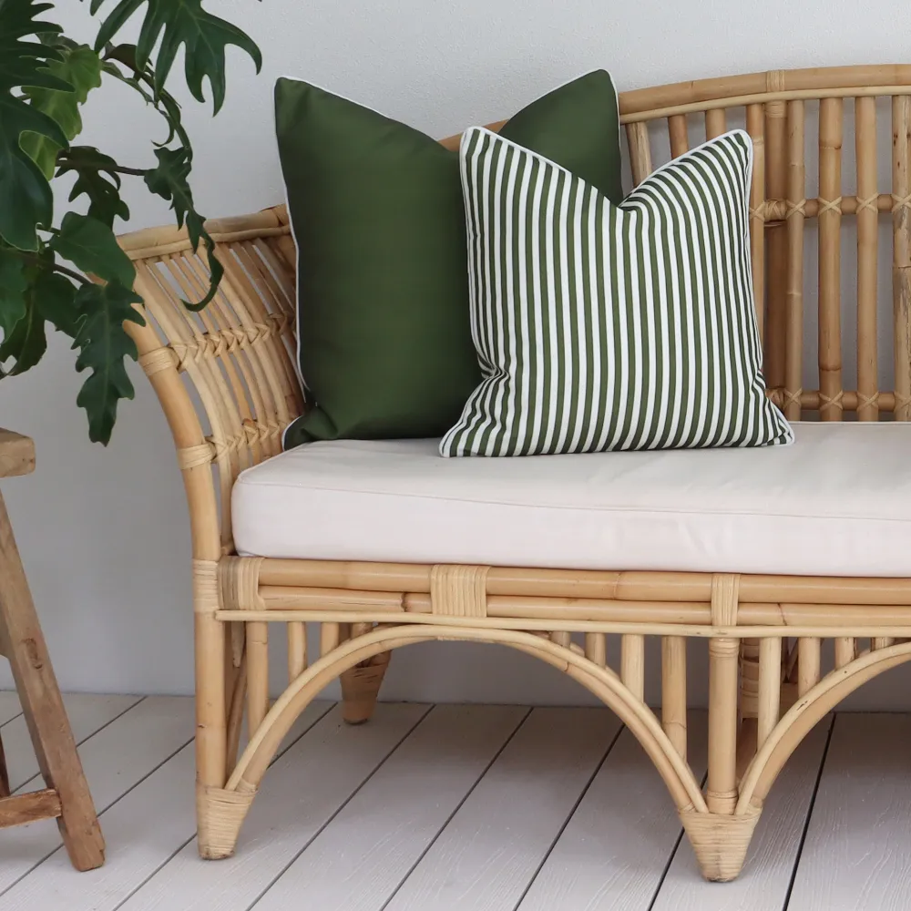 Green outdoor cushions sit prominently on a seat.