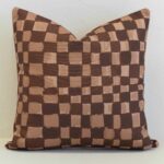 Sienna outdoor cushion with brown and beige checkered pattern.