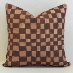 Sienna outdoor cushion with brown and beige checkered pattern.