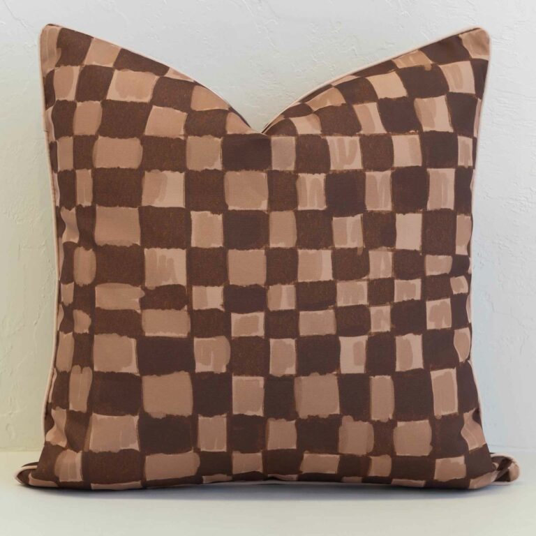 Sienna outdoor cushion with brown and beige checkered pattern.