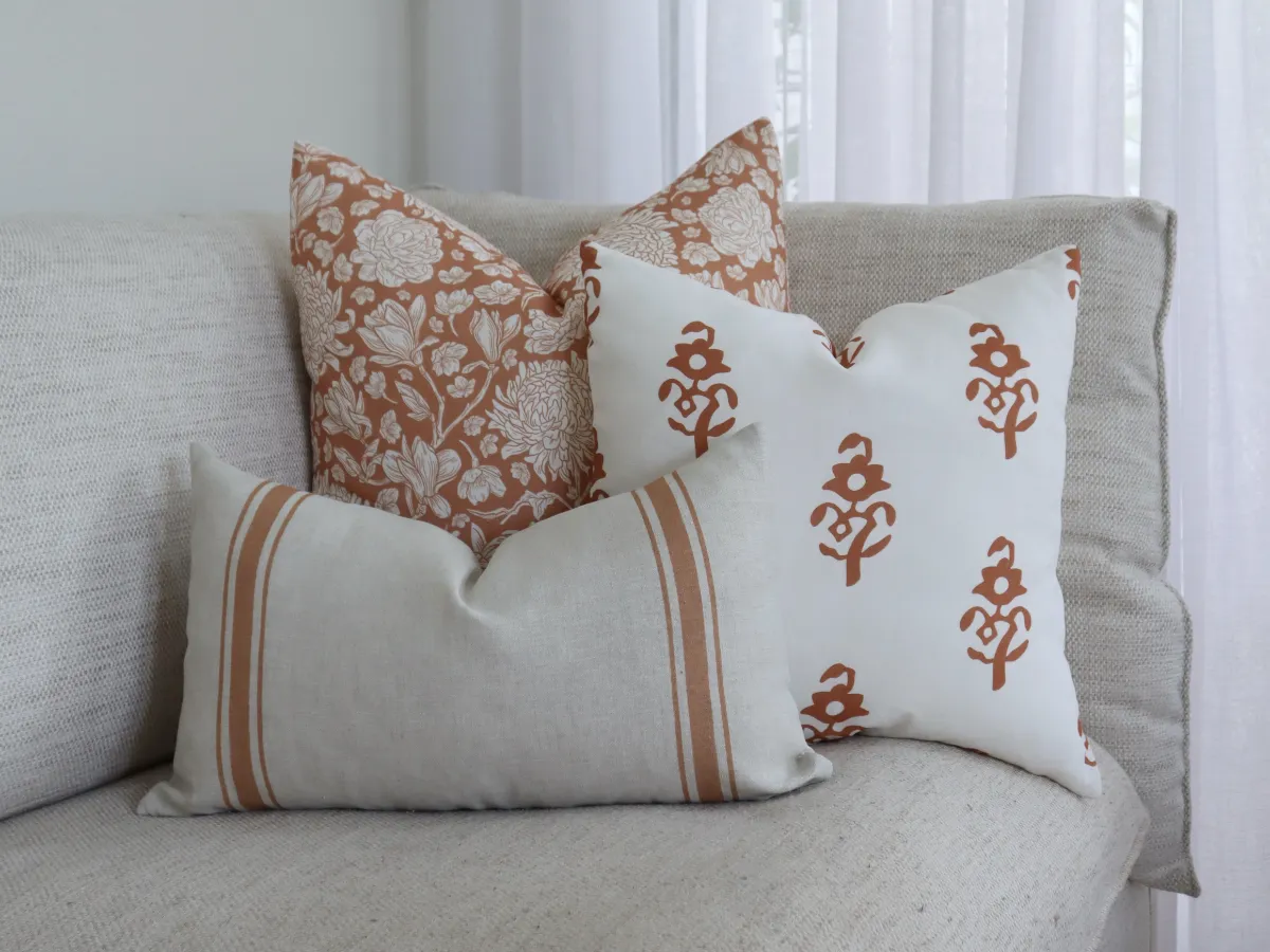 A simple selection of three indoor cushions arranged on a couch.