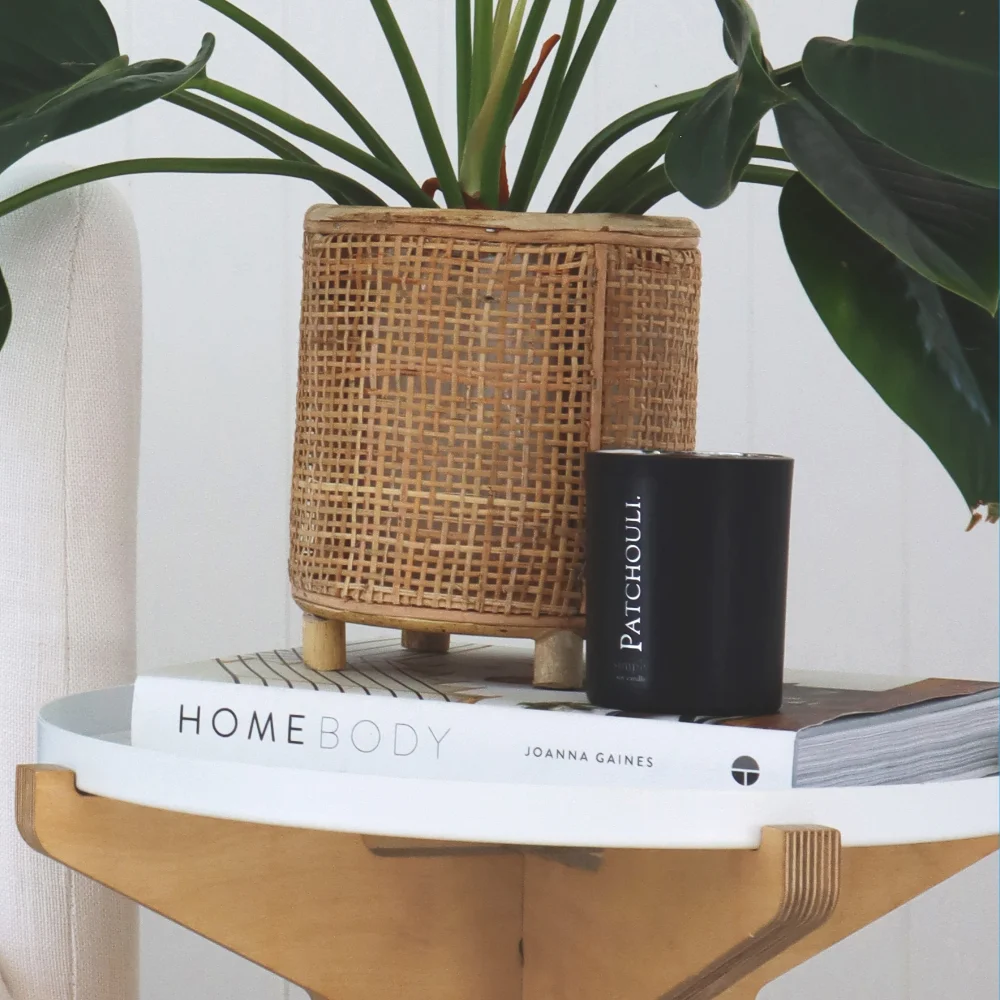 A small side table has a candle on its top.