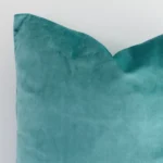 Macro image of a velvet square cushion cover. The shot shows the spearmint hue and solid colour style more thoroughly.