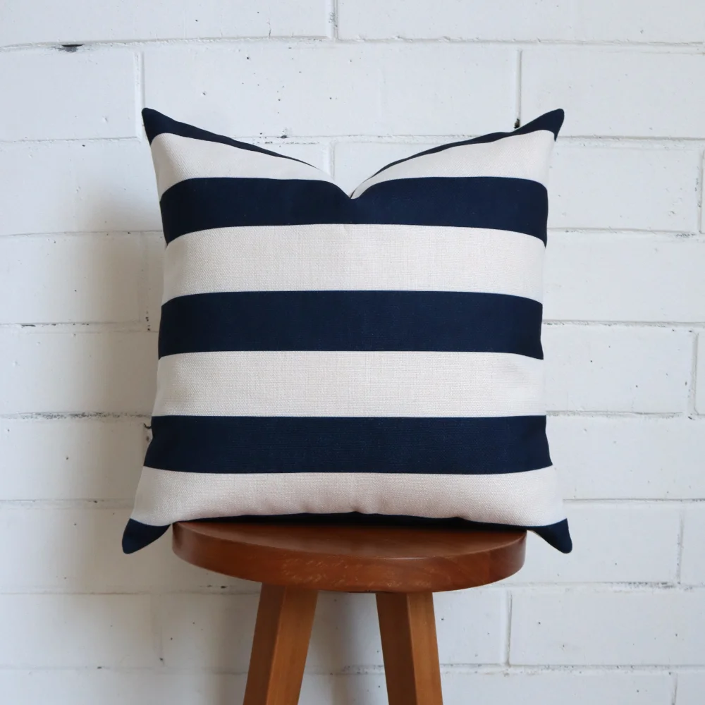 A tall stool stands featuring a blue and white cushion.