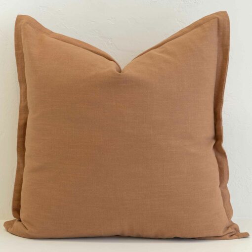 Tan linen cushion with warm earthy tone and soft textured finish.