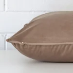 Side angle of brown cushion cover that has velvet fabric and a large size