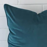 A magnified shot of a linen cushion cover in a large size and a teal colour.