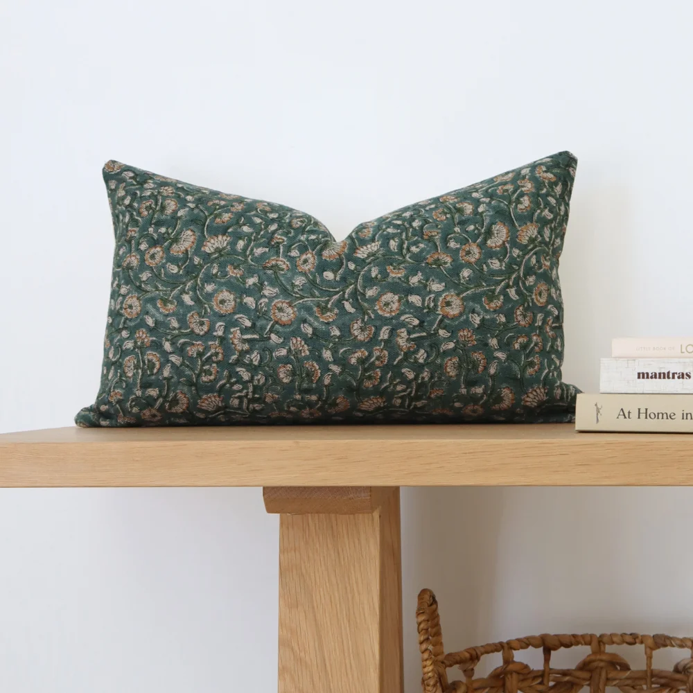 A timber bench shown with a 30x50 cushion cover arranged on top.