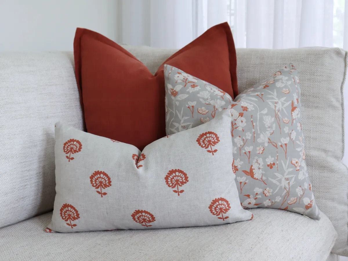 A trio of urban modern style cushions on a small couch.