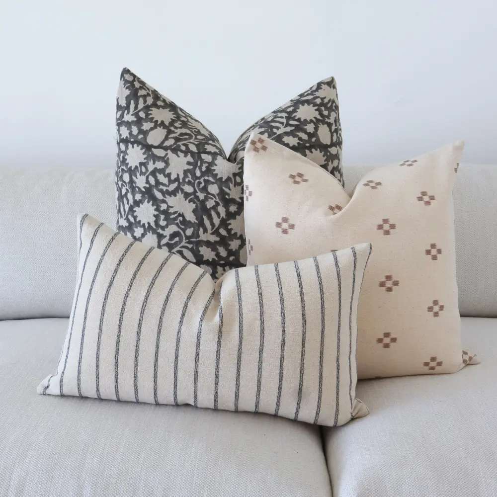 A three piece arrangement of vintage cushions.