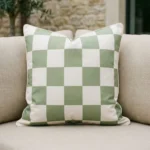 Tropica green check cushion with white squares on outdoor sofa.