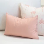 Tropica pink rectangular cushion with palm print cushion layered behind.