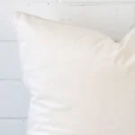 A close up shot showing the top left side of this large velvet cushion cover. The white tone is shown up close.