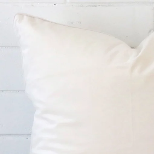 A close up shot showing the top left side of this large velvet cushion cover. The white tone is shown up close.