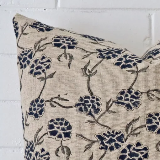 Zoomed photo of the top left corner of this floral cushion cover. The image clearly shows the designer material and large dimensions.